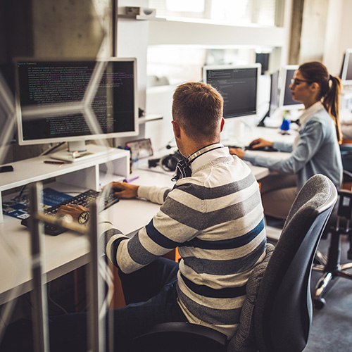 developers at their desks working on their computers
