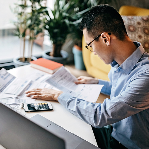 a practice owner entering numbers from various documents into their computer