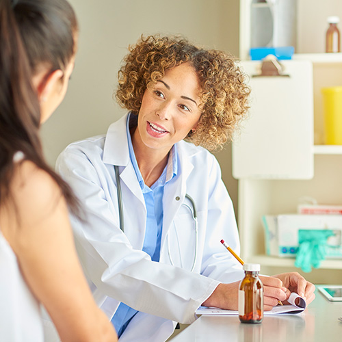 a doctor writing a prescription for a patient